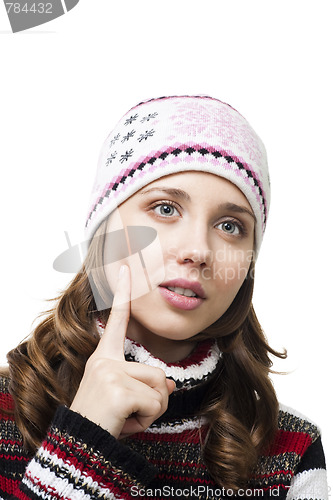Image of Face of a beautiful woman thinking in winter cap