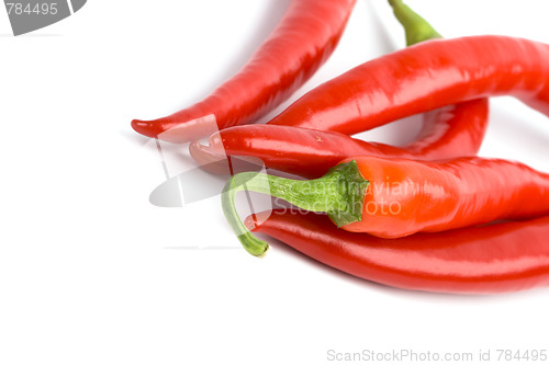 Image of five red chilli peppers