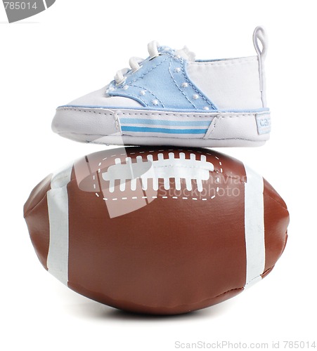 Image of Football with baby shoes