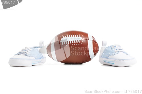 Image of Football with baby shoes