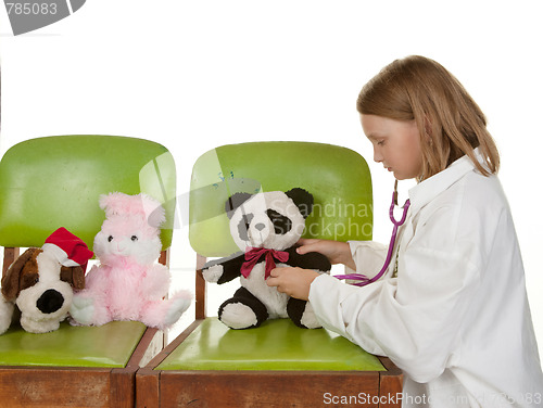 Image of girl playing doctor with her toys