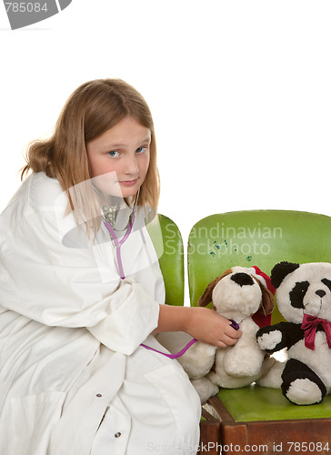 Image of girl playing doctor with her toys
