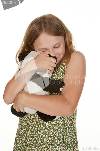 Image of girl hugging her teddy bear