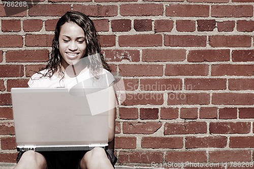 Image of Brick Wall Laptop Girl