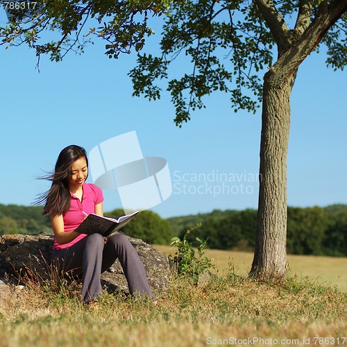 Image of Girl Writing in Note Book