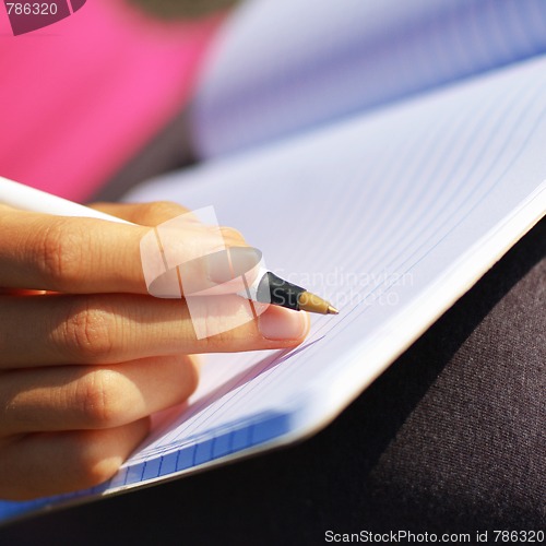 Image of Girl Writing in Note Book