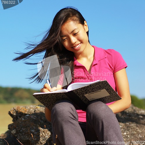 Image of Girl Writing in Note Book