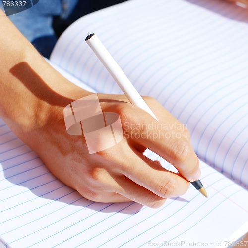 Image of Girl Writing In Note Book