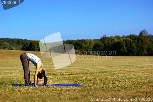 Image of Girl Practicing Yoga In Field