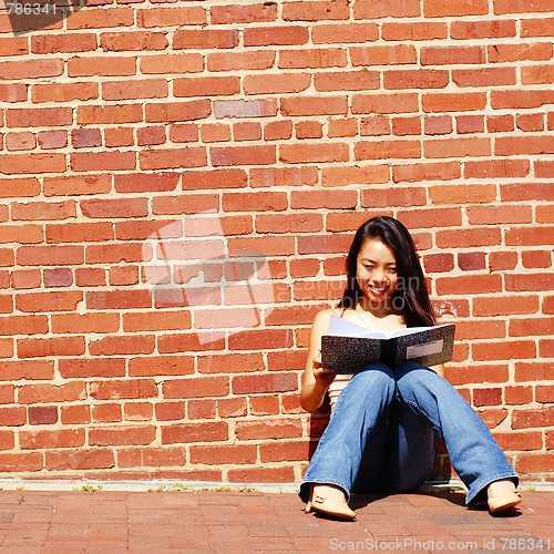 Image of Girl Writing In Note Book