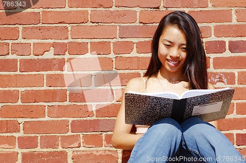 Image of Girl Writing In Note Book