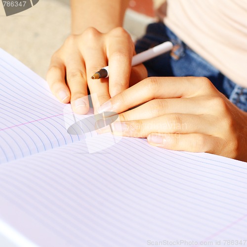 Image of Girl Writing In Note Book