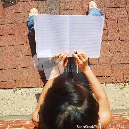 Image of Girl Writing In Note Book