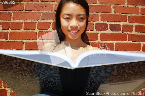 Image of Girl Writing In Note Book