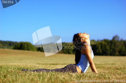 Image of Girl Practicing Yoga In Field