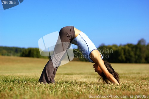 Image of Girl Practicing Yoga In Field