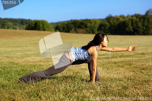 Image of Girl Practicing Yoga In Field