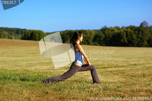 Image of Girl Practicing Yoga In Field