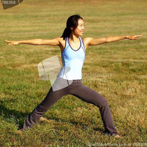 Image of Girl Practicing Yoga In Field