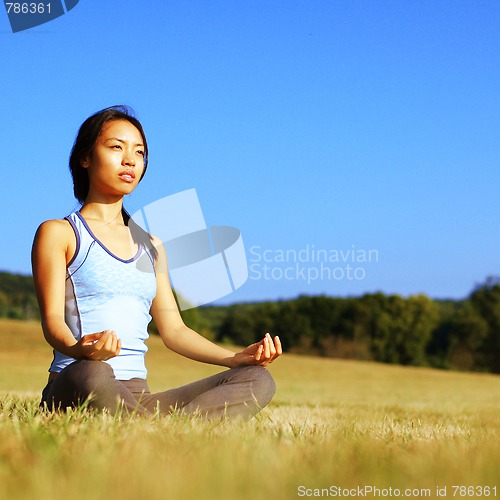 Image of Girl Practicing Yoga In Field