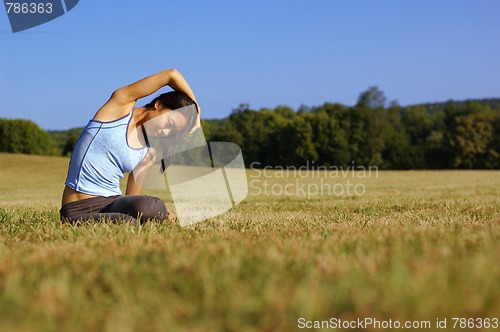 Image of Girl Practicing Yoga In Field