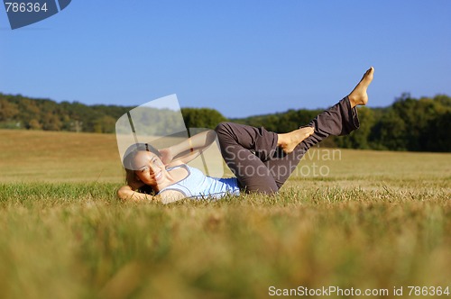 Image of Girl Practicing Yoga In Field