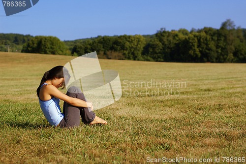 Image of Girl Practicing Yoga In Field