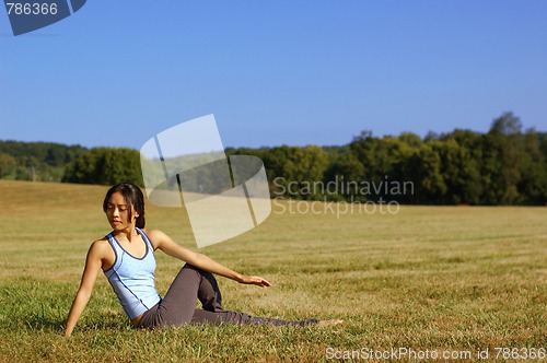 Image of Girl Practicing Yoga In Field