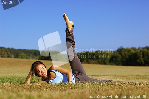 Image of Girl Practicing Yoga In Field