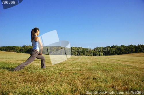 Image of Girl Practicing Yoga In Field