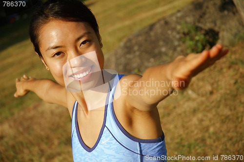 Image of Girl Practicing Yoga In Field