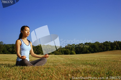 Image of Girl Practicing Yoga In Field