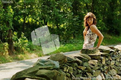Image of Pretty Girl Next to Stone Fence
