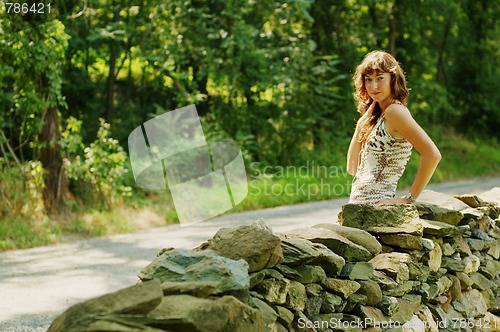 Image of Pretty Girl Next to Stone Fence
