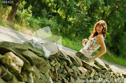 Image of Pretty Girl Next to Stone Fence