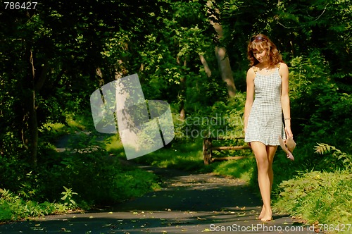 Image of Pretty girl on forest path