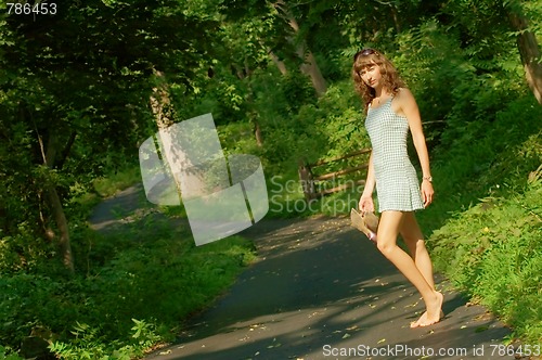 Image of Pretty girl on forest path