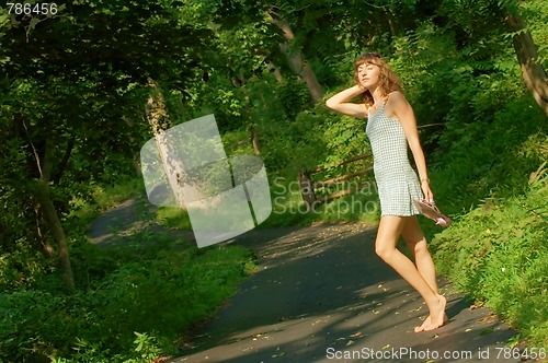 Image of Pretty girl on forest path