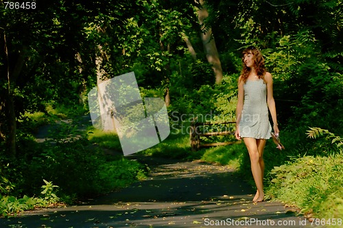 Image of Pretty girl on forest path