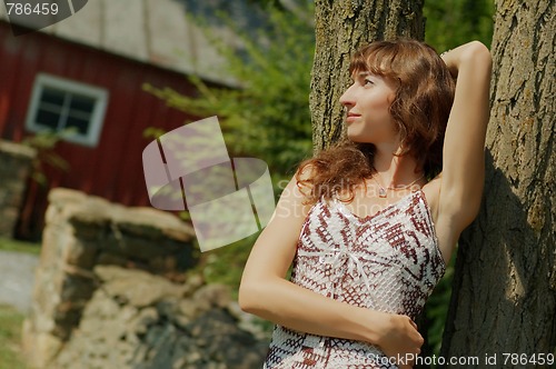 Image of Girl Leaning Against Tree