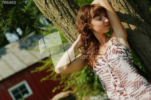 Image of Girl Leaning Against Tree