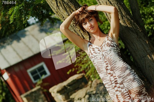 Image of Girl Leaning Against Tree
