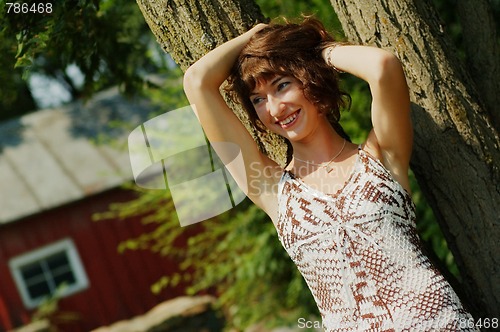 Image of Girl Leaning Against Tree