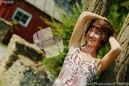 Image of Girl Leaning Against Tree