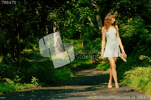 Image of Pretty girl on forest path