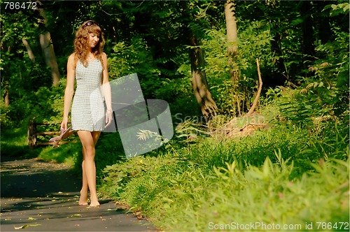 Image of Pretty girl on forest path