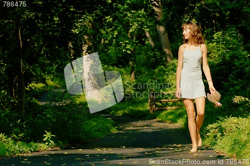 Image of Pretty girl on forest path