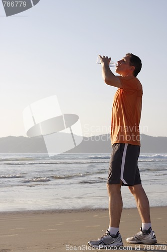 Image of Runner drinking water