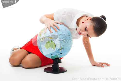 Image of Business woman searching county on the globe