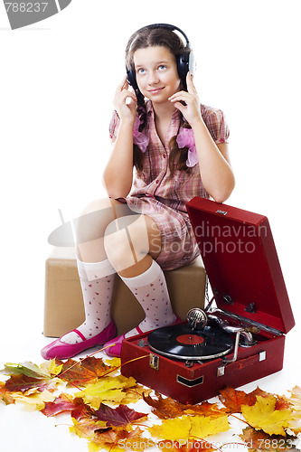 Image of Teenager girl listen music with gramophone